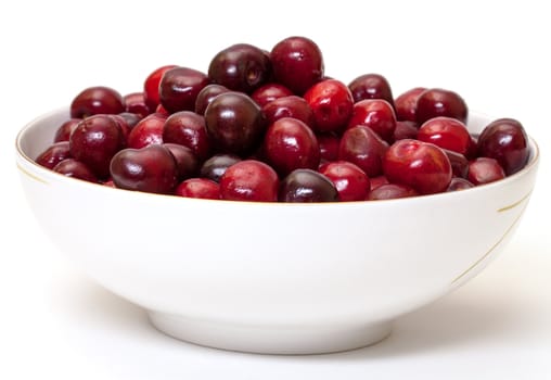 Bowl with Ripe Cherries, closeup on a white background