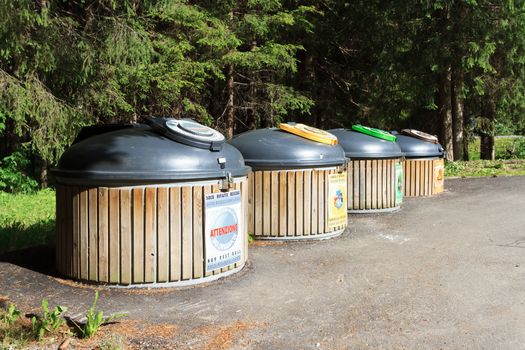 four wooden recycle bins for waste segregation 