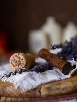 Wine cork with corkscrew on wooden board in warm natural lighting. Macro with extremely shallow DOF