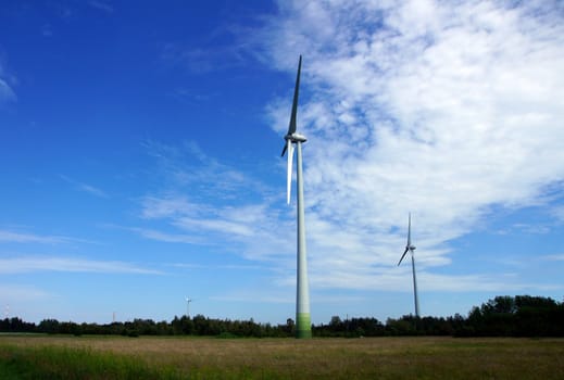 The wind generator on a background of the nature and the sky