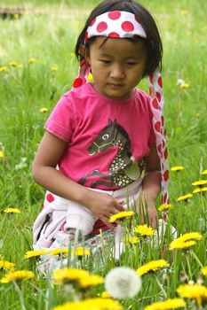 Cute girl in flowers in spring
