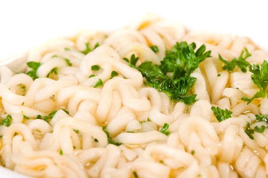 Noodles and parsley soup on white background