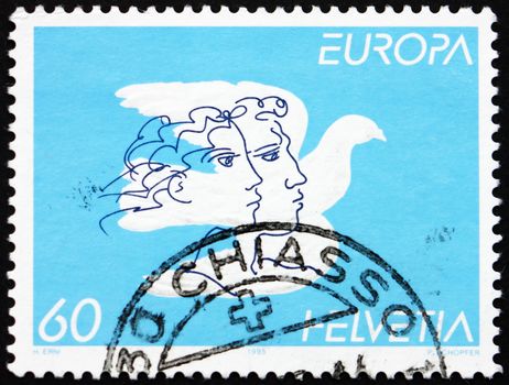 SWITZERLAND - CIRCA 1995: a stamp printed in the Switzerland shows Dove and faces, Peace and Freedom, circa 1995