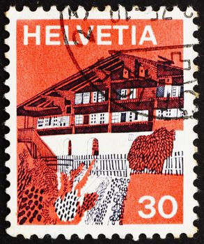 SWITZERLAND - CIRCA 1973: a stamp printed in the Switzerland shows Village in Simme Valley, Switzerland, circa 1973