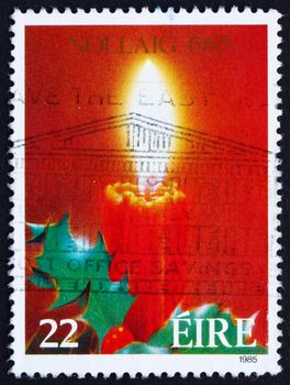 IRELAND - CIRCA 1985: a stamp printed in the Ireland shows Candle and Holy, Christmas, circa 1985