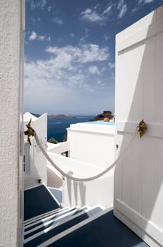 Santorini Caldera view with cliffs and boats trough the open door of the building