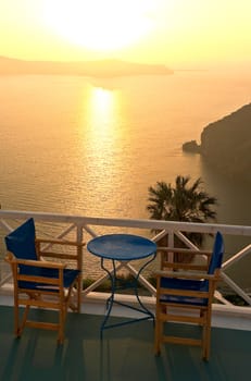 Idyllic balcony with a table and chairs above the sea 