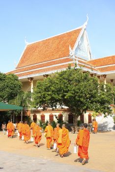 Buddhist monks walking in the courtyard of Wat Ounalom, Phnom Penh, Cambodia