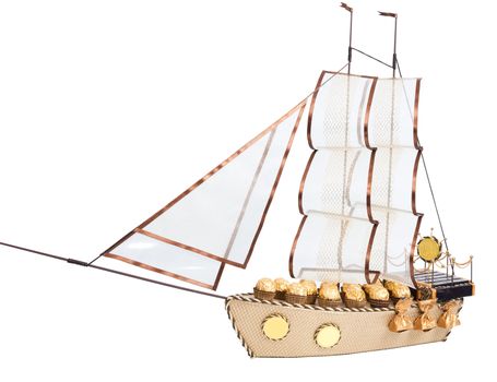 gift in form layout sailing ship decorated with candy isolated on white