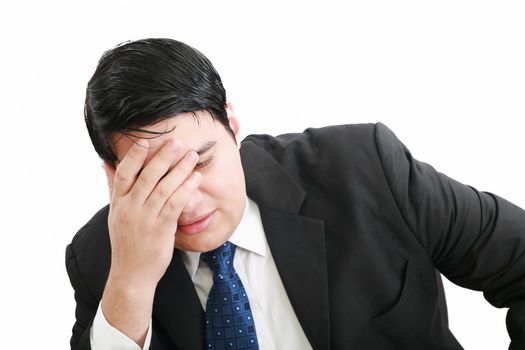 Portrait of a young business man depressed from work against white background