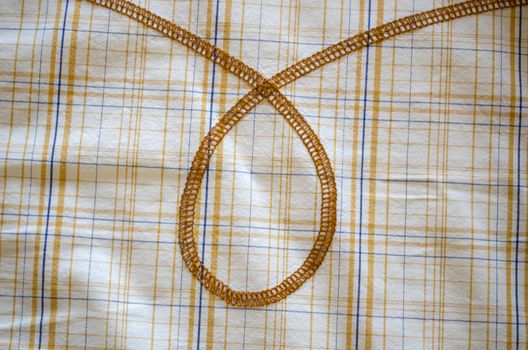loop ornament on orange blue lines square fabric shirt background.
