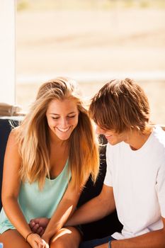 Young beautiful couple having fun in a beach bar