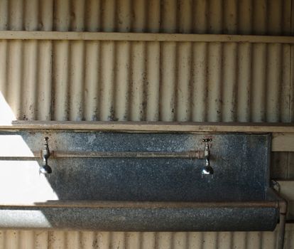 Australian Grunge Old School Taps over grungy retro tin drinking trough