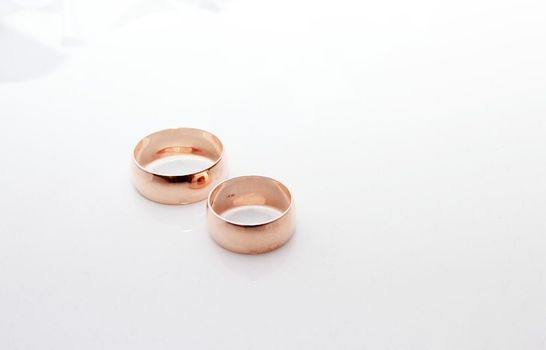 Wedding rings on a white background with wedding decorationsding Rings
