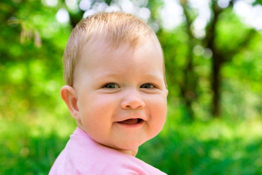 Smiling baby in a wood