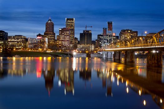 Portland Oregon Downtown City Skyline with Hawthorne Bridge along Willamette River at Blue Hour