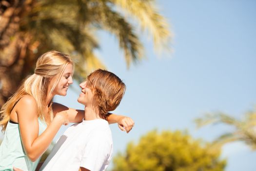 Young romantic beautiful couple enjoying on a walkside with threes