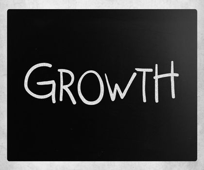 "Growth" handwritten with white chalk on a blackboard.