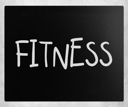 "Fitness" handwritten with white chalk on a blackboard.