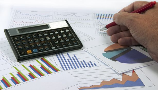 data graphics analysis with calculator and writing hand