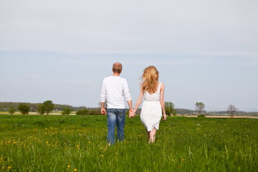 young happy couple have fun in summer outdoor in nature