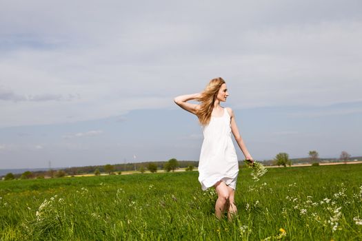 beautiful blonde woman outdoor in summer happy