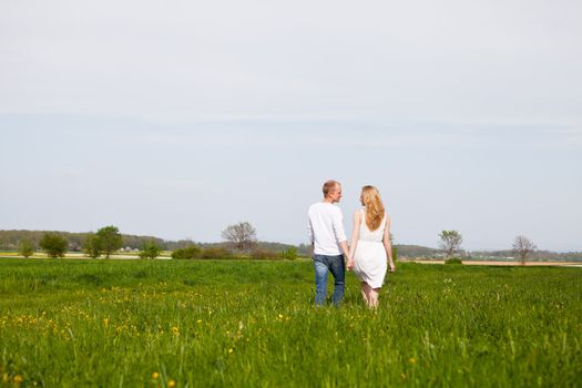 young happy couple have fun in summer outdoor in nature