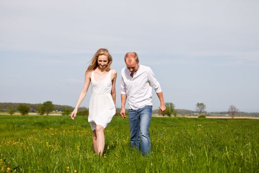 young happy couple have fun in summer outdoor in nature