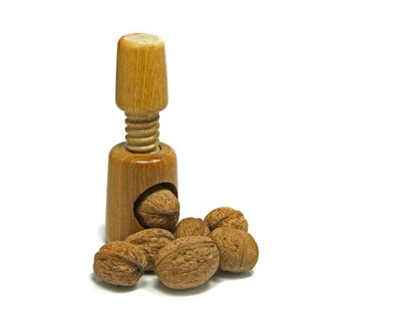 wooden nutcracker isoalted on white with walnuts