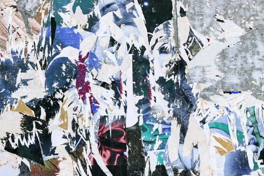 grunge background on billboard with old torn posters 