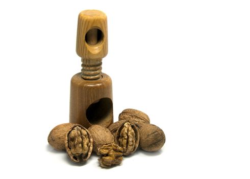 wooden nutcracker isoalted on white with walnuts