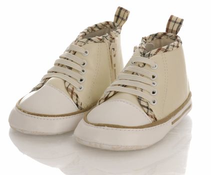 baby or infant running shoes with reflection on white background