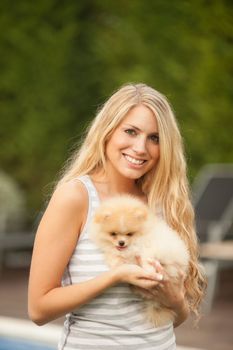 young woman playing with her tinny dog at home