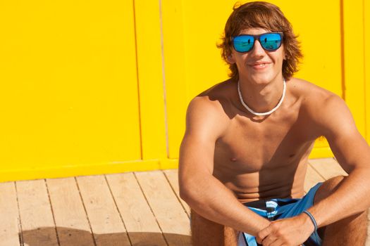 handsome man watching the sea on a lifeguard house