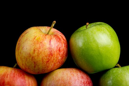 Apples in a row on black backround