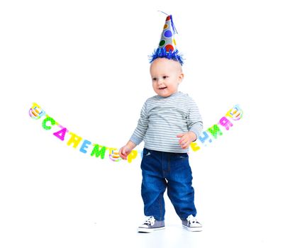 Cute funny little boy in first birthday with colored balloons. In the studio