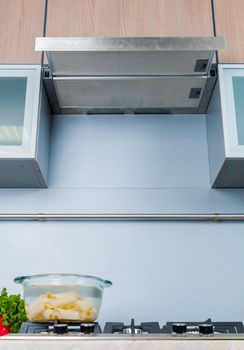 Clouseup range hood - detail of a modern kitchen. Vertical view