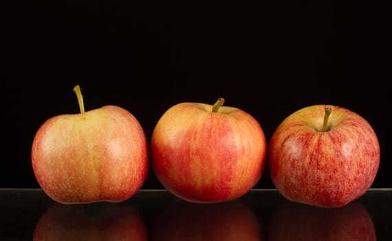 Apples in a row on black backround