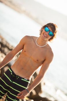 young healthy beautiful men portrait laughing on the beach