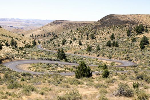 Long Winding Highway Along High Desert Farmland Landscape in Central Oregon
