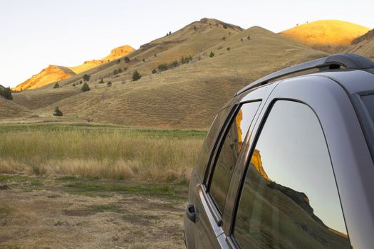 Reflection of Central High Desert Landscape on Sports Utility Vehicle Windows