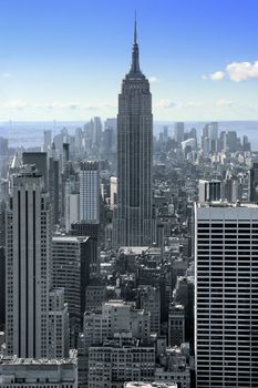 Photo of the landscape of buildings in New York city with the Empire State Building in the center.