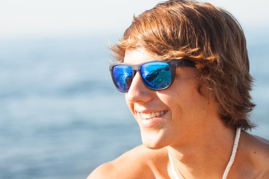 young healthy beautiful men portrait laughing on the beach