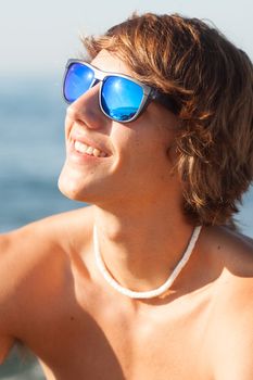 young healthy beautiful men portrait laughing on the beach