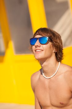 young healthy beautiful men portrait laughing on the beach