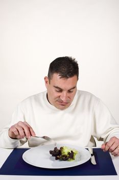 Frustrated guy with his leaf of salad