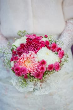 Bride holding purpur wedding bouquet in the yours hand. Vertical view