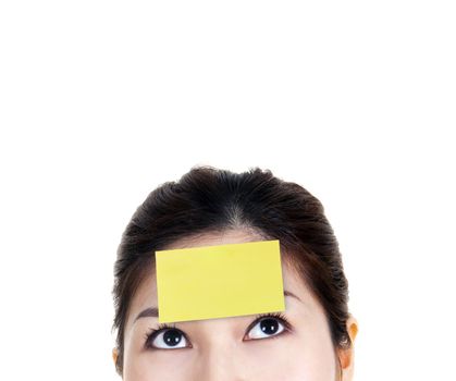 Young Asian woman with yellow sticky note on forehead.