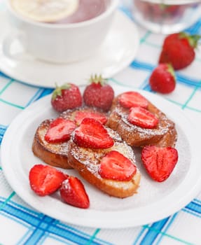 French toasts with powdered sugar and a strawberry