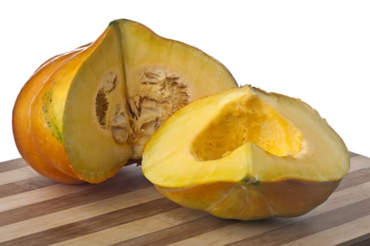 a small yellow squash on a bamboo cutting board 